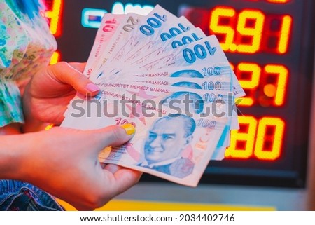 The girl's Hands holding Turkish Lira and American Dollar. Concept of the money exchange Royalty-Free Stock Photo #2034402746
