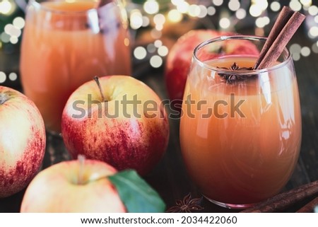 Fresh apple cider drink with star of anise and cinnamon. Selective focus on juice with extreme blurred background and foreground.