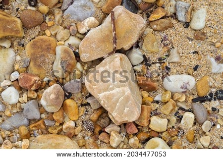 Texture of sand and stones on the beach