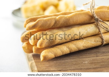 Grissini sticks. Traditional italian bread sticks on cutting board. Royalty-Free Stock Photo #2034478310