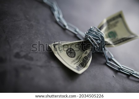 Business concept. The depreciation of national currency. Hundred dollar bill. Inflation and stagnation. Tighten the hundred dollar bill with a measuring chain. Royalty-Free Stock Photo #2034505226