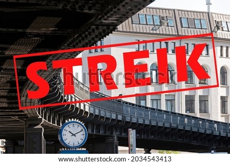 Banner with German text Streik (meaning strike) over an image with a clock under the curve of a suburban railway bridge in the city of Hamburg, Germany, traffic concept, selected focus