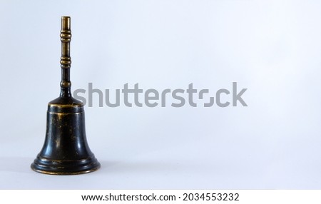 Hand bell on white background. Selective focus. Copy space.