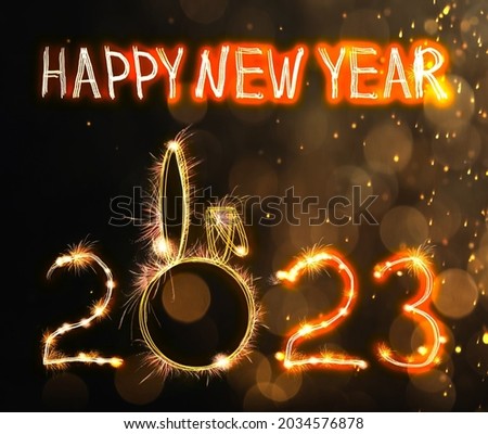 Bright text Happy New 2023 Year made of firework on dark background. Greeting card design