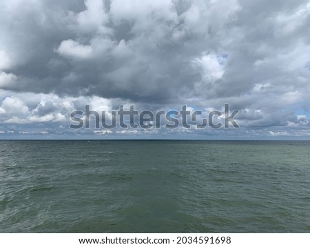 Dark clouds at the sea, stormy weather, dramatic seascape
