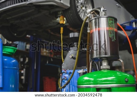 Close-up of old used automatic transmission fluid in the Reservoir oil level indicator tube on the waste oil drain tank. Royalty-Free Stock Photo #2034592478