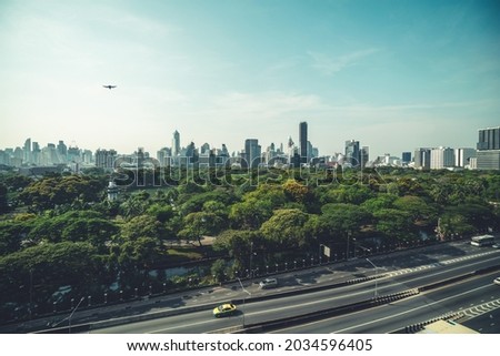 Public park and high-rise buildings cityscape in metropolis city center . Green environment city and downtown business district in panoramic view . Royalty-Free Stock Photo #2034596405