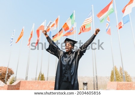 happy african american male college graduate at ceremony