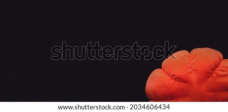 Orange pumpkin on a black background in grunge and matte style without any text. Minimalistic background for autumn holidays with space for text, copy space, banner