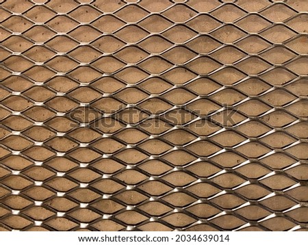Metal lattice on the wall made of chipboard. Indoor decor element