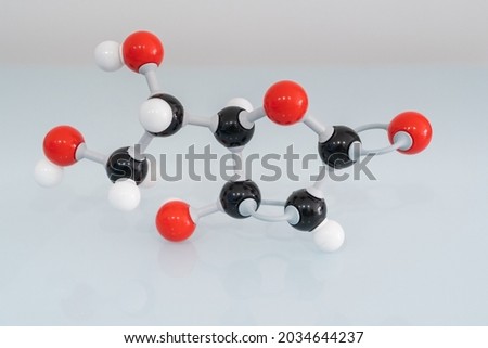 Isolated vitamin C made by molecular model with reflection on white background. Ascorbic acid chemical formula with colored atoms and bonds. Royalty-Free Stock Photo #2034644237