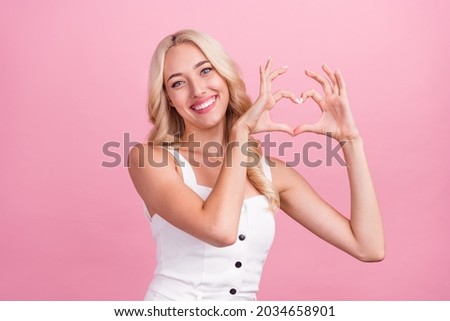 Photo of young attractive girl happy positive smile show fingers heart symbol love isolated over pink color background