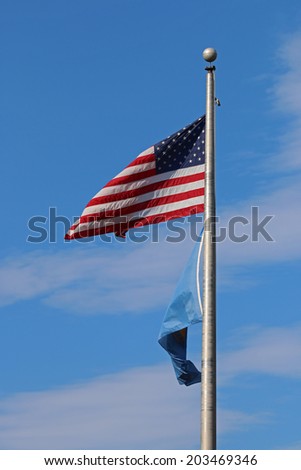 US American and Bergen County, NJ Flags Waving in the Wind with the Beautiful Blue Sky in Background.