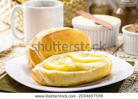 slice of salt bread cut with butter, called French bread in Brazil, Brazilian breakfast Royalty-Free Stock Photo #2034697598