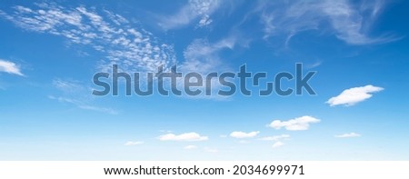 Blue sky and white clouds floated in the sky on a clear day with warm sunshine combined with cool breeze blowing against the body resulting in a miraculous refreshing like paradise