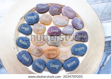 Motivational zen inspirational stones with writings. Serenity, gratitude, passion, believe, love on a background
 Royalty-Free Stock Photo #2034709205