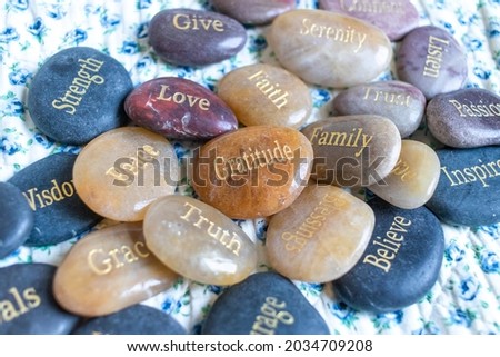 Motivational zen inspirational stones with writings. Serenity, gratitude, passion, believe, love on a background
 Royalty-Free Stock Photo #2034709208