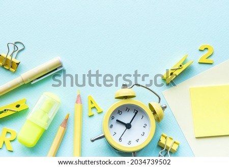 Frame of different stationery on blue background, flat lay with space for text. Back to school