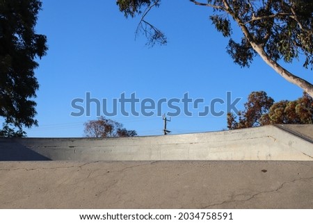 concrete skate ramp against blue sky