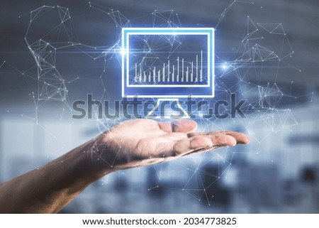 Hand holding abstract polygonal computer monitor hologram on blurry interior background. Digital transformation, technology and innovation concept