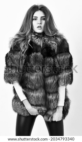 Fur fashion concept. Winter elite luxury clothes. Female brown fur coat. Fur store model posing in soft fluffy warm coat. Pretty fashionista. Woman makeup and hairstyle posing mink or sable fur coat