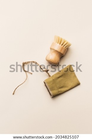Eco friendly natural cleaning tools and products. Burlap price tag and natural brush on beige trends background. Zero waste concept. Plastic free. Flat lay, top view