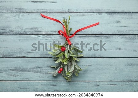 Mistletoe branch on wooden background