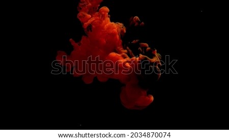 Abstract background photo colored paints in water on a black background
