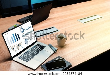 Top view mock up sales summary slide show presentation on display laptop with coffee cup on table in meeting room