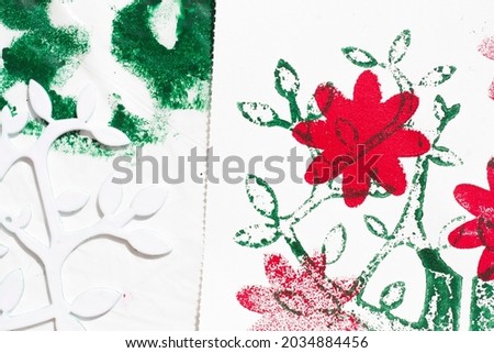 stamping with sponge and template of a tree and flowers. Stencil craft.