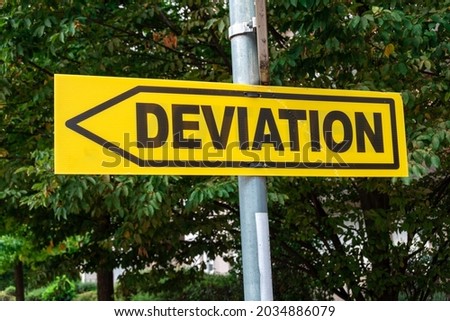 Yellow road sign with a direction arrow and the word "DEVIATION" written in French. Concepts of change and modification