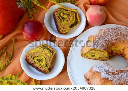 Bread texture of home baked potica, sweet bread roll stuffed with poppy seeds and walnuts in pumpkin dough. Slices of babka with poppy seeds and walnut filling. Colourful sweet bread cake with fruits.