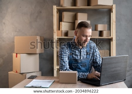 Small business aspiring entrepreneur, small and medium business freelance working in home office using computer, online marketing packaging box delivery, SME e-commerce telemarketing concept. Royalty-Free Stock Photo #2034896222