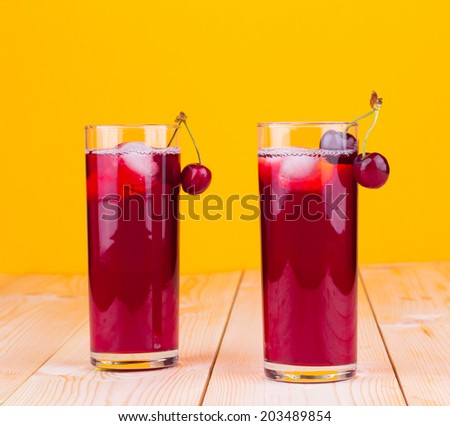 red fruit cocktail decorate with cherry on wooden background