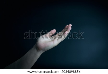 Symbol by hand. supplication and faith, intercession, encouragement gesture of male hands on black background with copy space