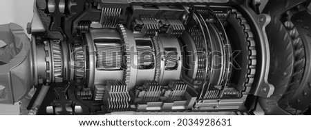 Planetary gears inside automatic transmission in the context. Metal mechanism. Steel. Engineering. Heavy industry. Concept - production of metal spare parts. Industrial topics Royalty-Free Stock Photo #2034928631