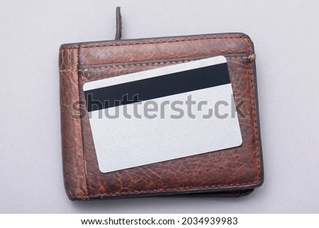 Blank plastic credit card on brown leather wallet. Business concept picture