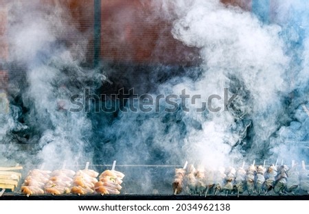 Barbecue, bbq smoke and fire, grilled meat. Heavy smoke over barbeque meat