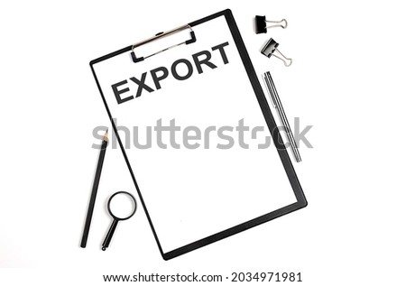 On a white background magnifier, a pen and a sheet of paper with the text EXPORT . Business