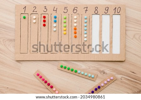 Insert a suitable strap with cotton balls into the designated cavity with the number. Pre-school education assistance for kindergartens. children learn the Montessori IQ early. Math task for baby.