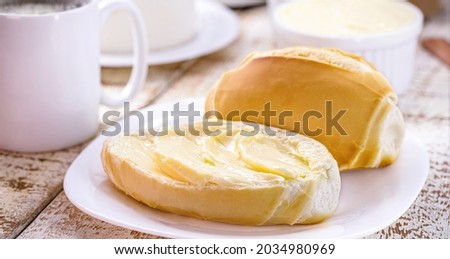 slice of salt bread cut with butter, called French bread in Brazil, Brazilian breakfast Royalty-Free Stock Photo #2034980969