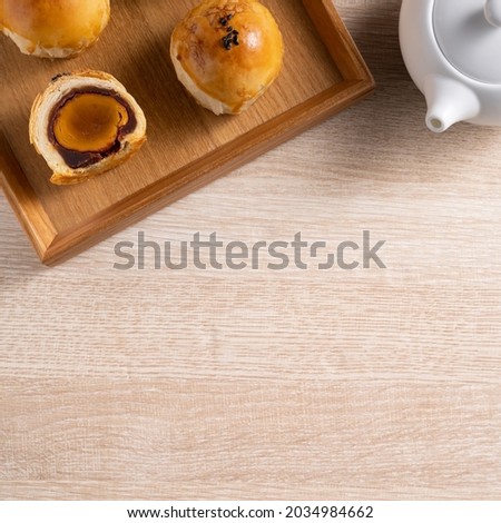 Top view design concept of Moon cake yolk pastry, mooncake for Mid-Autumn Festival holiday on wooden table background