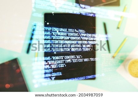 Multi exposure of abstract software development hologram and digital tablet on background, top view, research and analytics concept