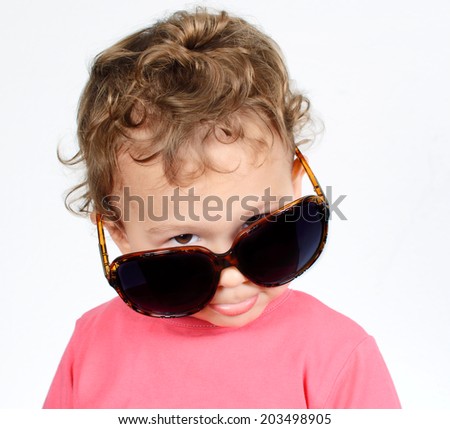 Funny little child with sunglasses on white background 