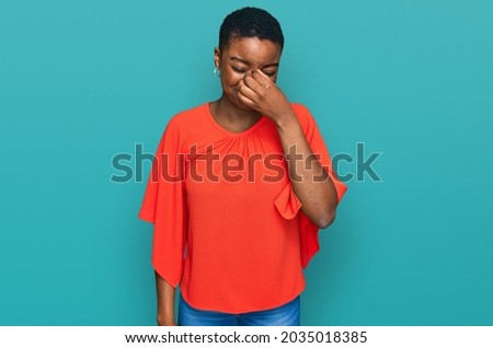Young african american woman wearing casual clothes tired rubbing nose and eyes feeling fatigue and headache. stress and frustration concept. 