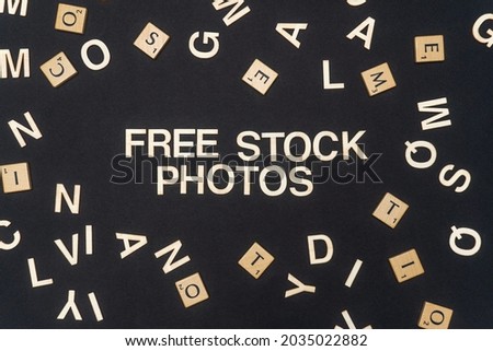 FREE STOCK PHOTOS word written on dark paper background. FREE STOCK PHOTOS text on dark for your designs, concept.