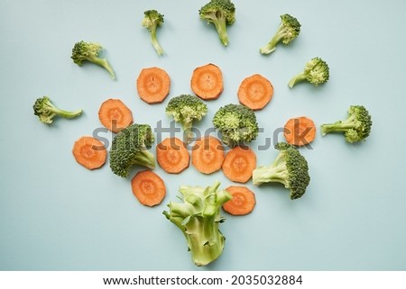 Carrots and broccoli - healthy food flower top view. High quality photo