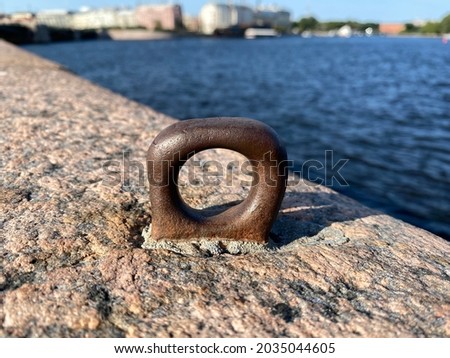 Mooring ring on the parapet of the granite embankment Royalty-Free Stock Photo #2035044605