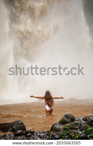 Beautiful woman near a waterfall in Bali