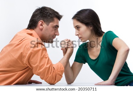 Man and woman doing arm wrestling showing their displeasure